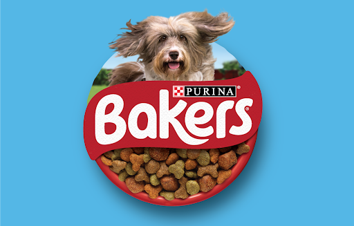 a dog is jumping out of a bowl of bakers dog food .