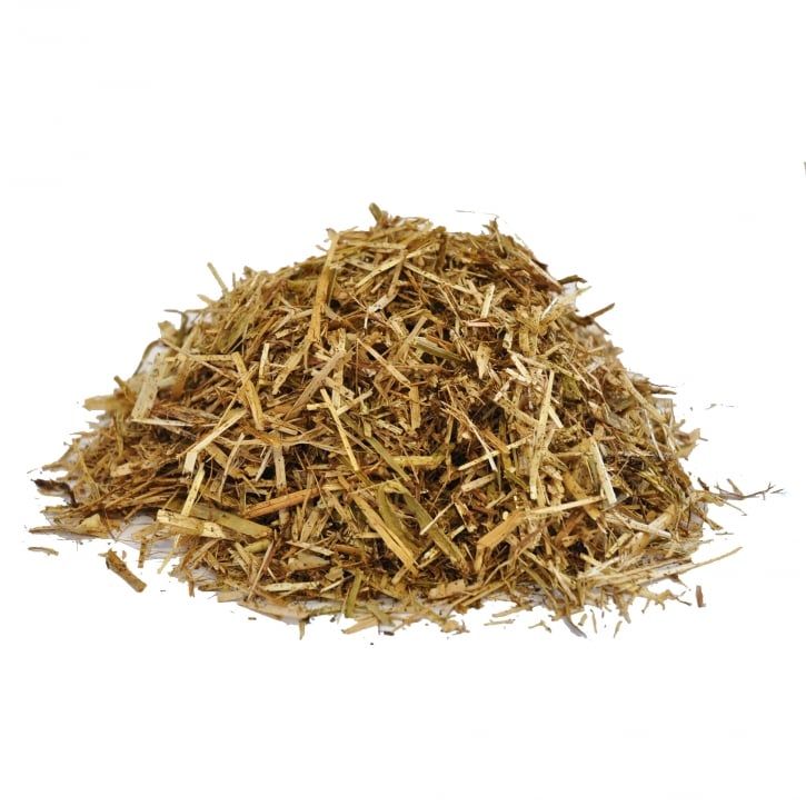 a pile of hay is sitting on a white surface