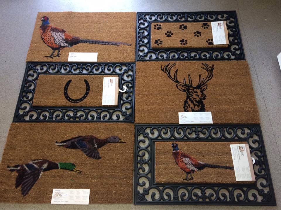 a bunch of door mats with animals on them