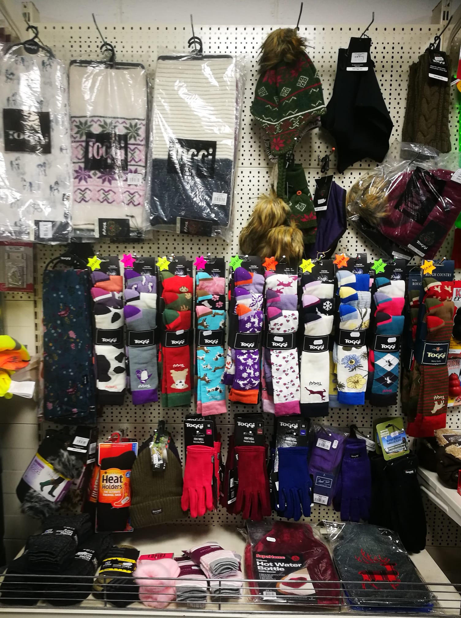 a display of socks and hats including one that says ' toggi ' on it