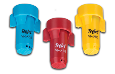 three different colored teejet spray nozzles are sitting next to each other on a white surface .