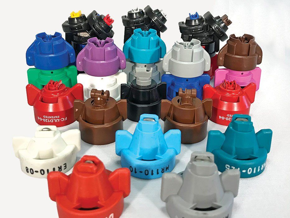 a bunch of different colored spray nozzles are sitting on a table