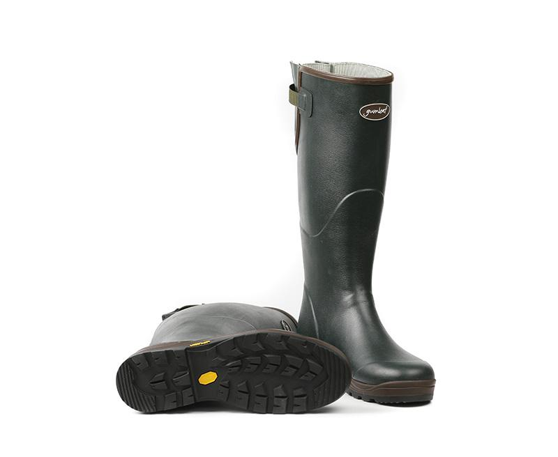 a pair of green rain boots with a brown rubber sole