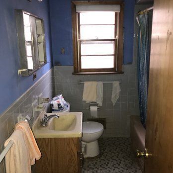 A bathroom with a sink , toilet and window