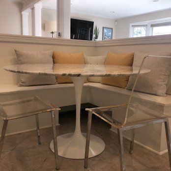 There is a table and chairs in the corner of the room.