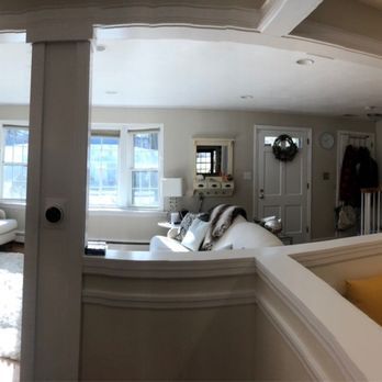 A living room with a couch and a mirror