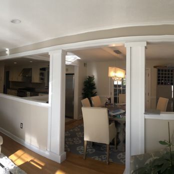 A living room with a table and chairs in it