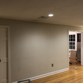 A living room with hardwood floors and white walls.