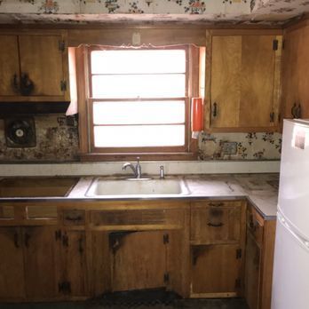 A kitchen with wooden cabinets and a white refrigerator