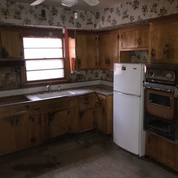 A kitchen with wooden cabinets and a white refrigerator