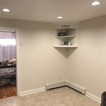 There is a corner shelf in the corner of the room.