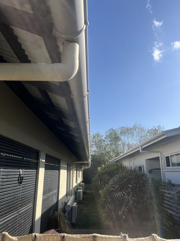 A Gutter on the Side of a Building With a Blue Sky in the Background — John Day Plumbing in Marlow Lagoon, NT