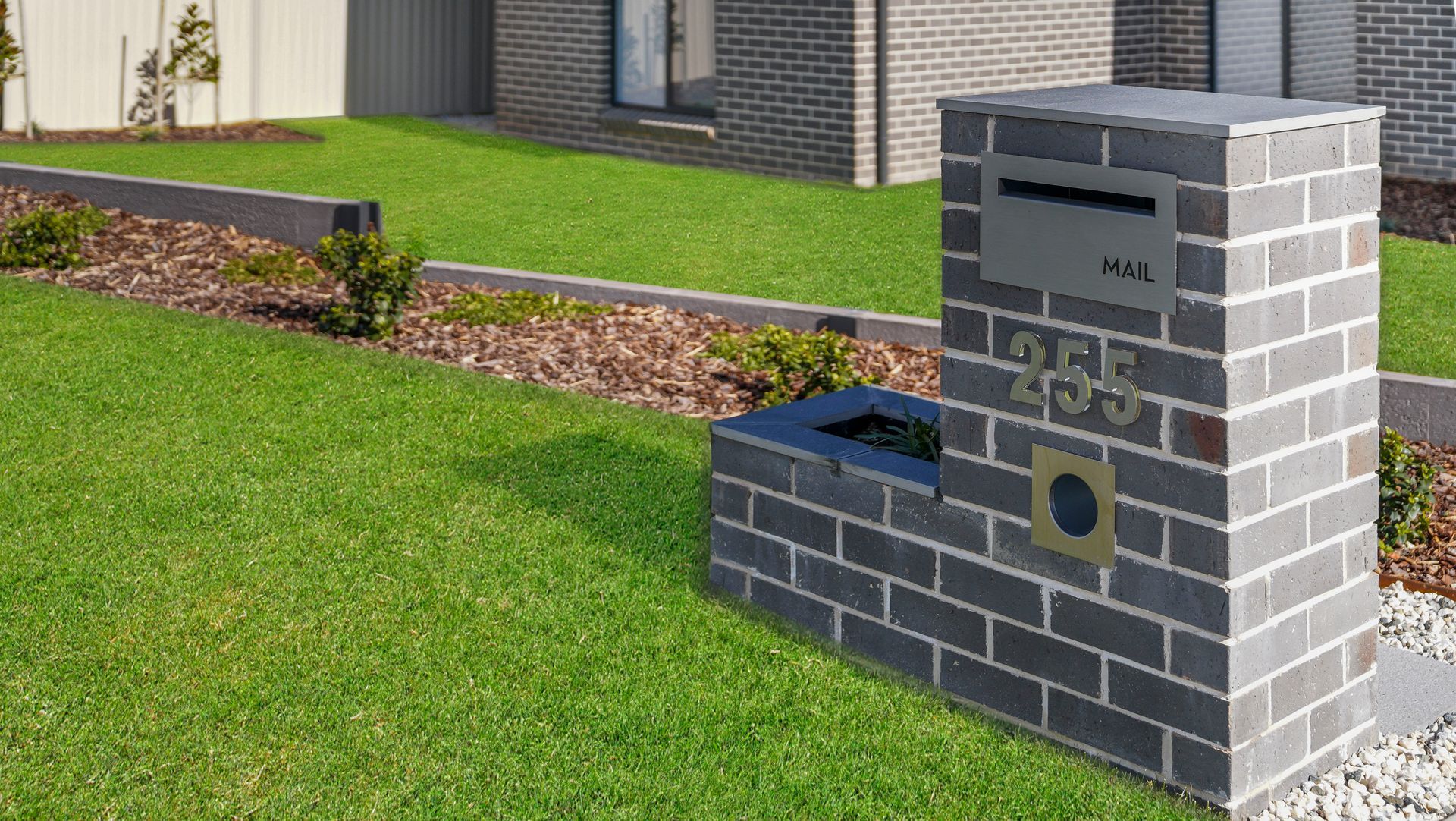 Formal landscape construction in Bathurst NSW- concrete sleeper retaining walls, native-exotic garden beds and manicured lawn