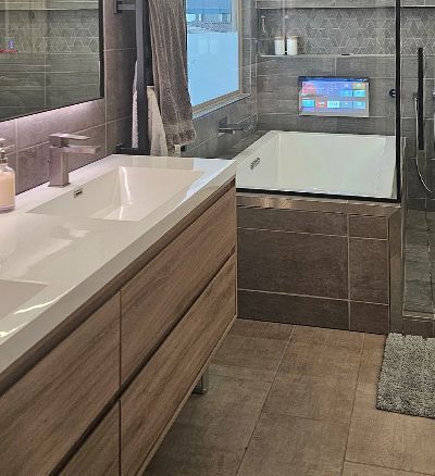 A bathroom with two sinks , a tub and a shower.