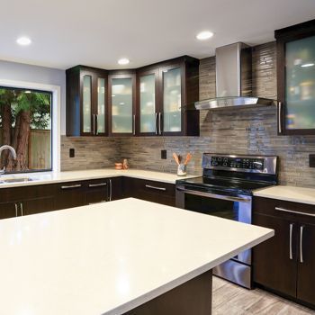 A kitchen with stainless steel appliances and wooden cabinets