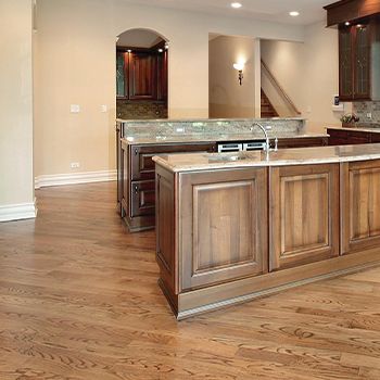 A kitchen with a large island and a sink.