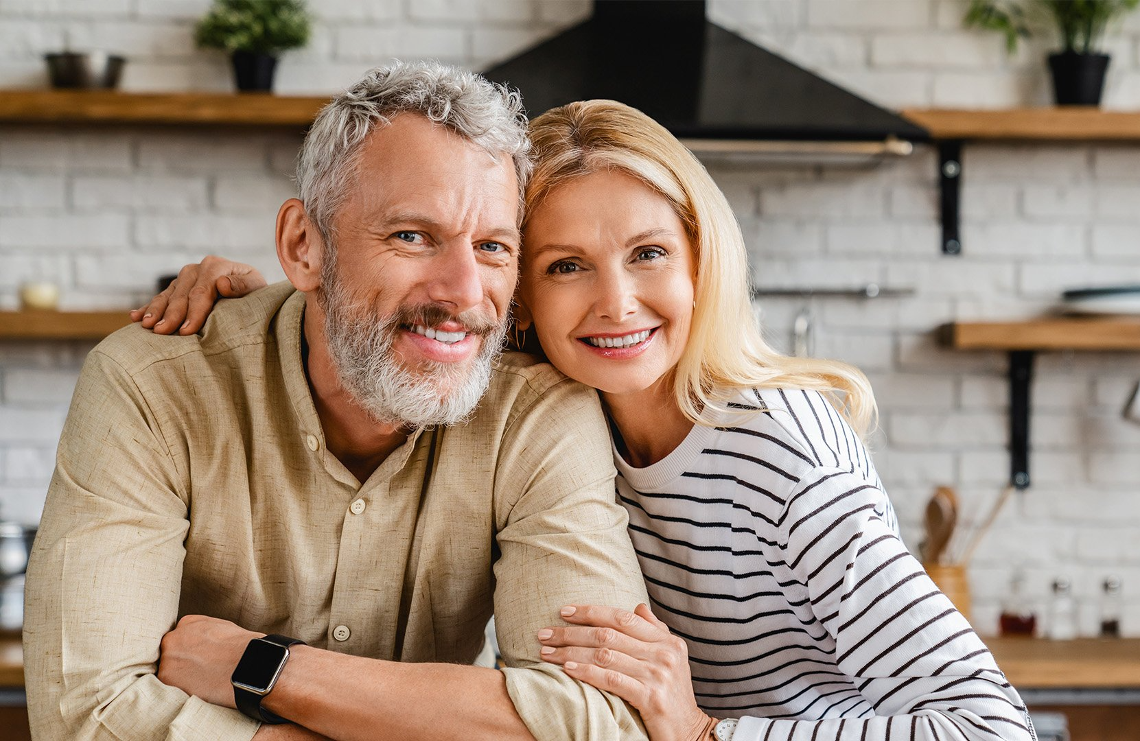 Older couple hugging in a house
