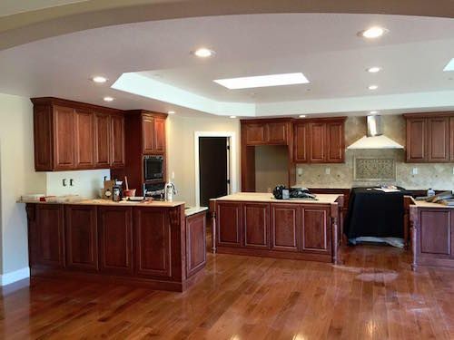 A large kitchen with wooden cabinets and hardwood floors