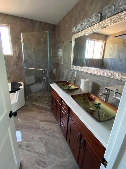 A bathroom with two sinks and a large mirror