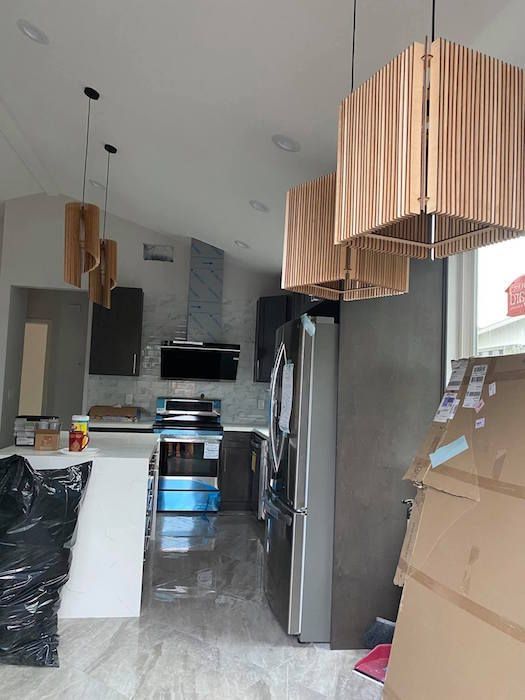 A kitchen with a refrigerator and a stove in it