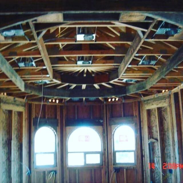 A room with arched windows and a wooden ceiling