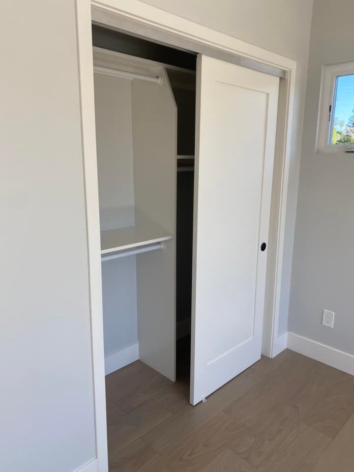 A closet with a shelf and a sliding door