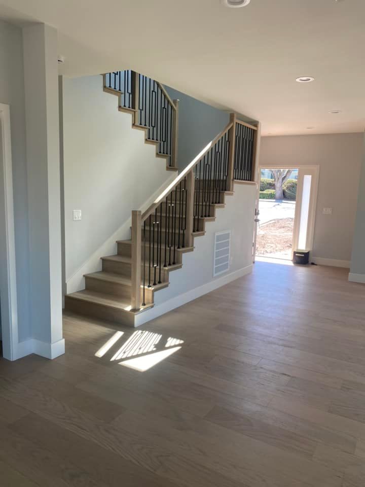 An empty room with a staircase leading up to the second floor