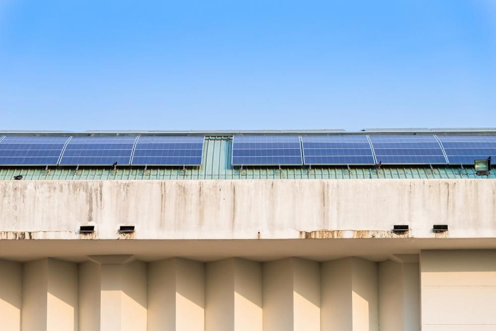 A Row of Solar Panels on the Roof of a Building — Power & Data Support Services In Mt Isa, QLD