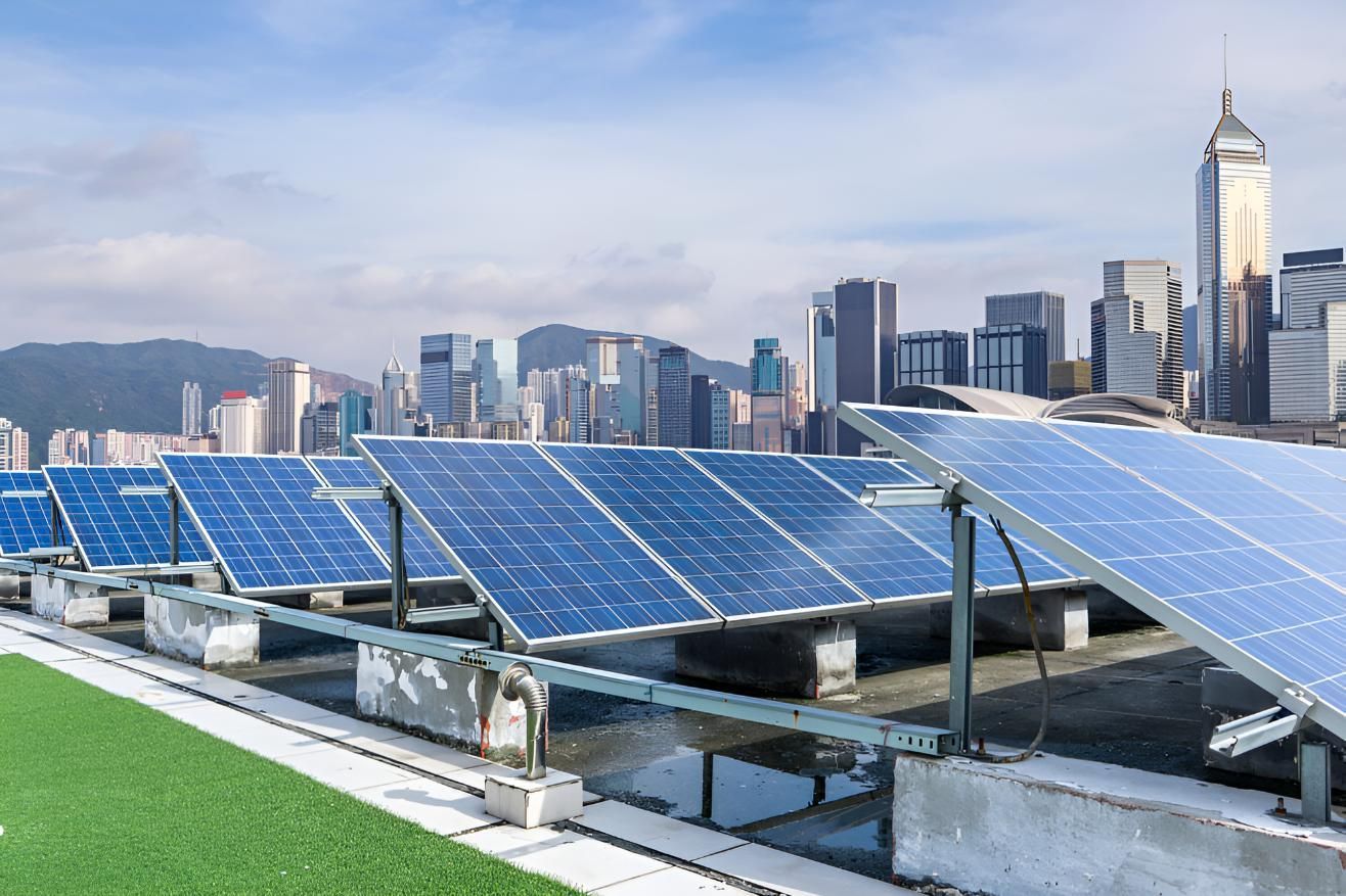 A Row of Solar Panels on Top of a Building With a City Skyline — Power & Data Support Services In Thursday Island, QLD