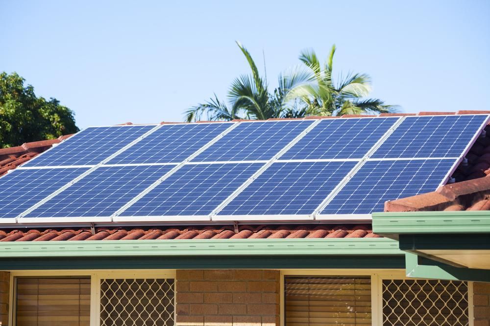 A House With a Lot of Solar Panels on the Roof — Power & Data Support Services In Ingham, QLD