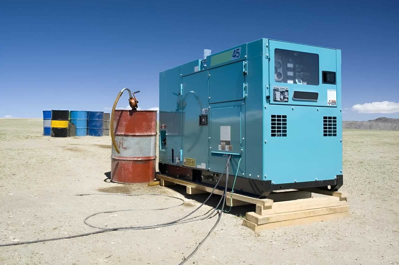 A Blue Generator is Sitting in the Middle of a Desert — Power & Data Support Services In Mapoon, QLD
