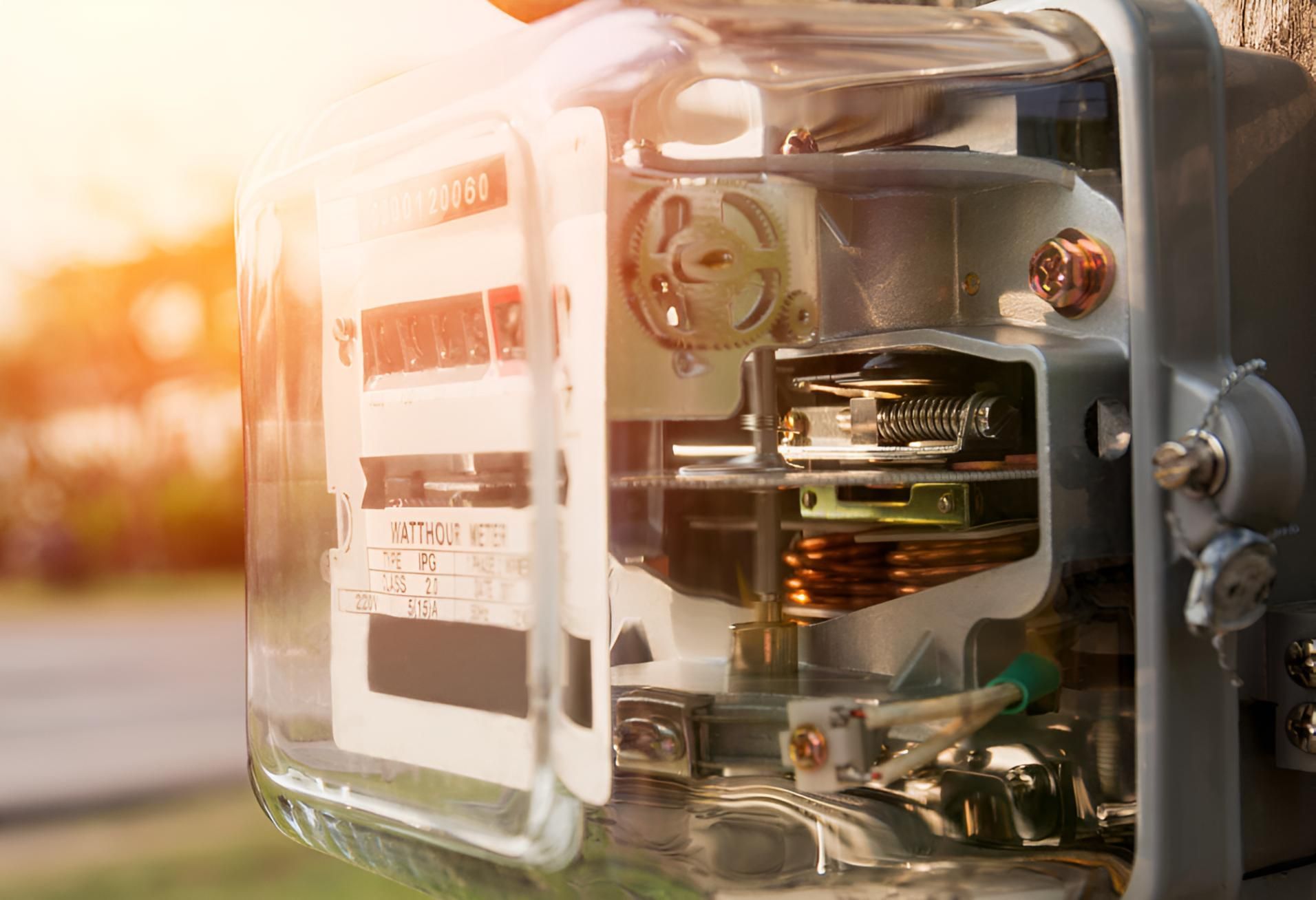 A Close Up of an Electric Meter With the Sun Shining Through It — Power & Data Support Services In Cardwell, QLD