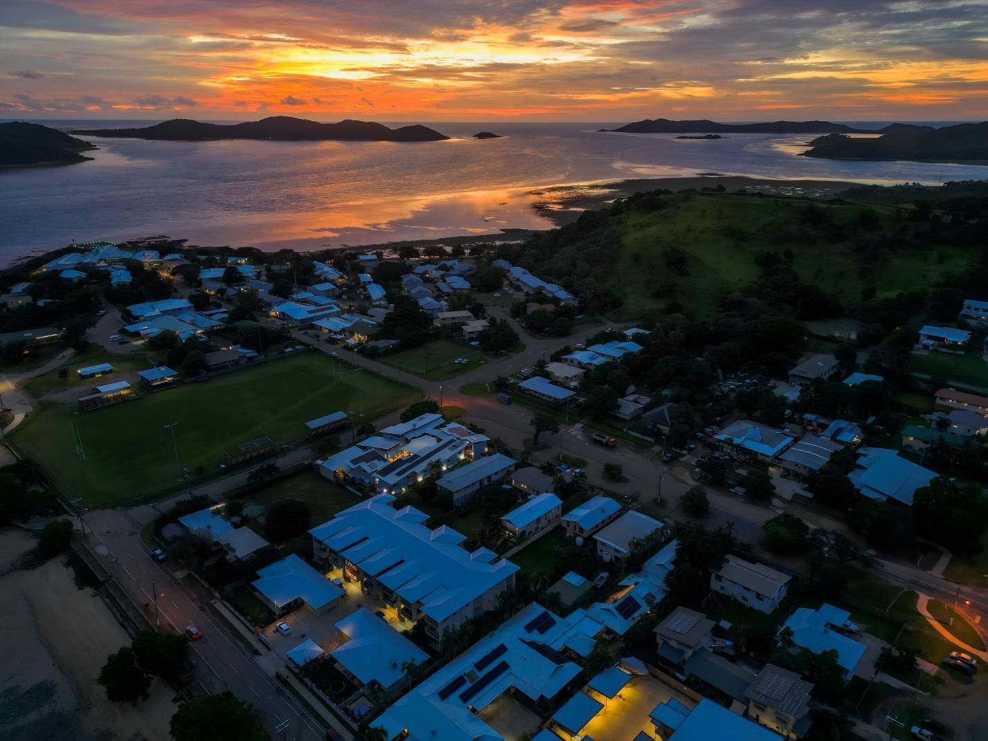 An Aerial View of a City at Sunset With a Large Body of Water — Power & Data Support Services In Thursday Island, QLD