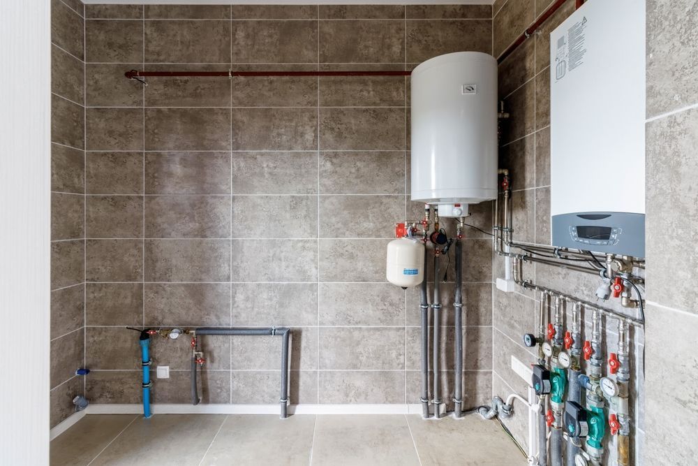 A basement with a water heater and a furnace.