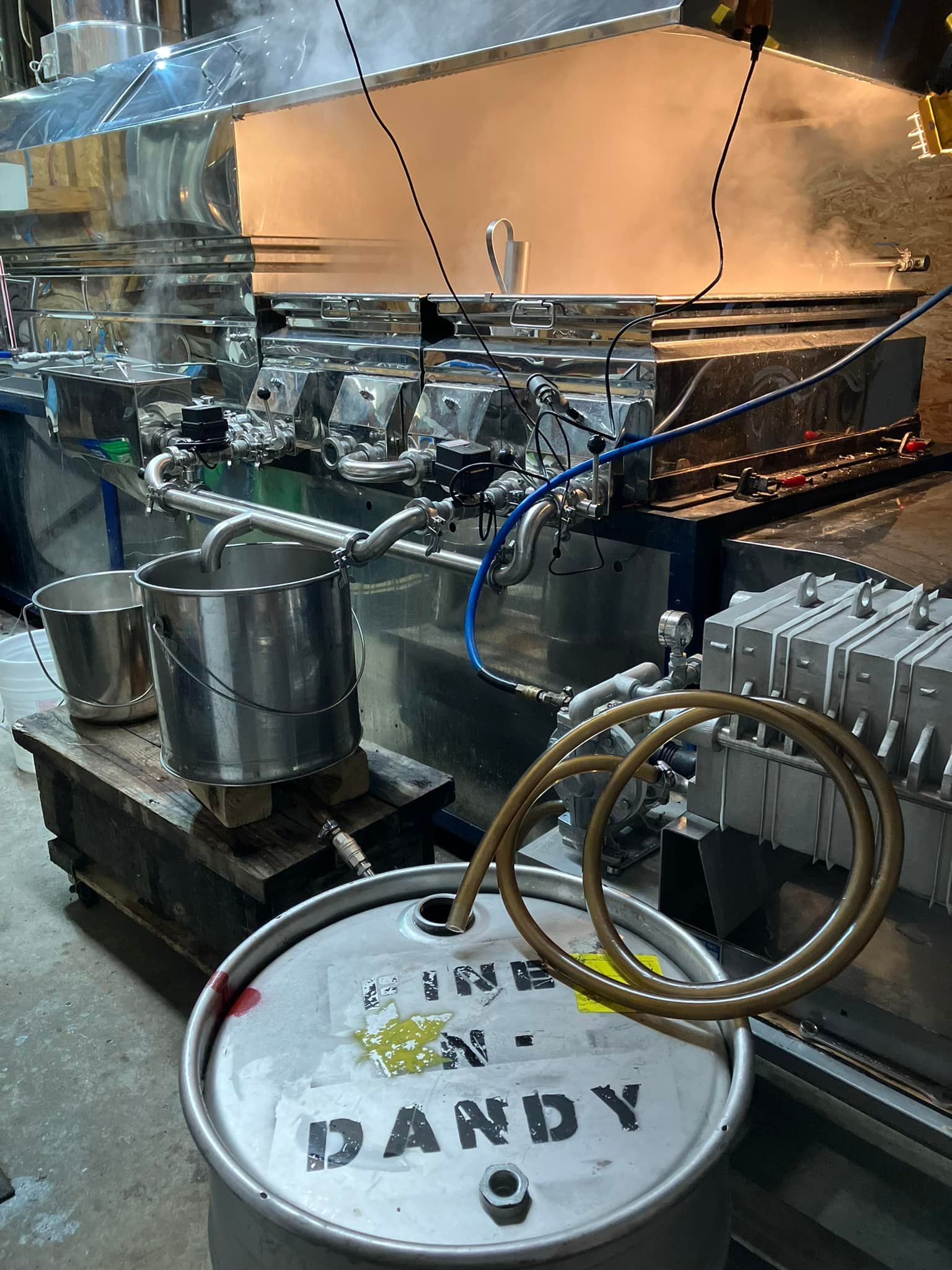 A barrel with the word dandy on it is in a kitchen.