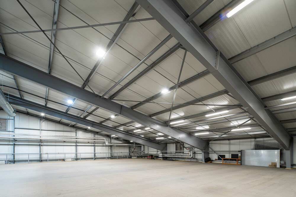 A Large Empty Warehouse With A Lot Of Lights — Shop Fittings Office Furniture Materials Handling In Gosford, NSW