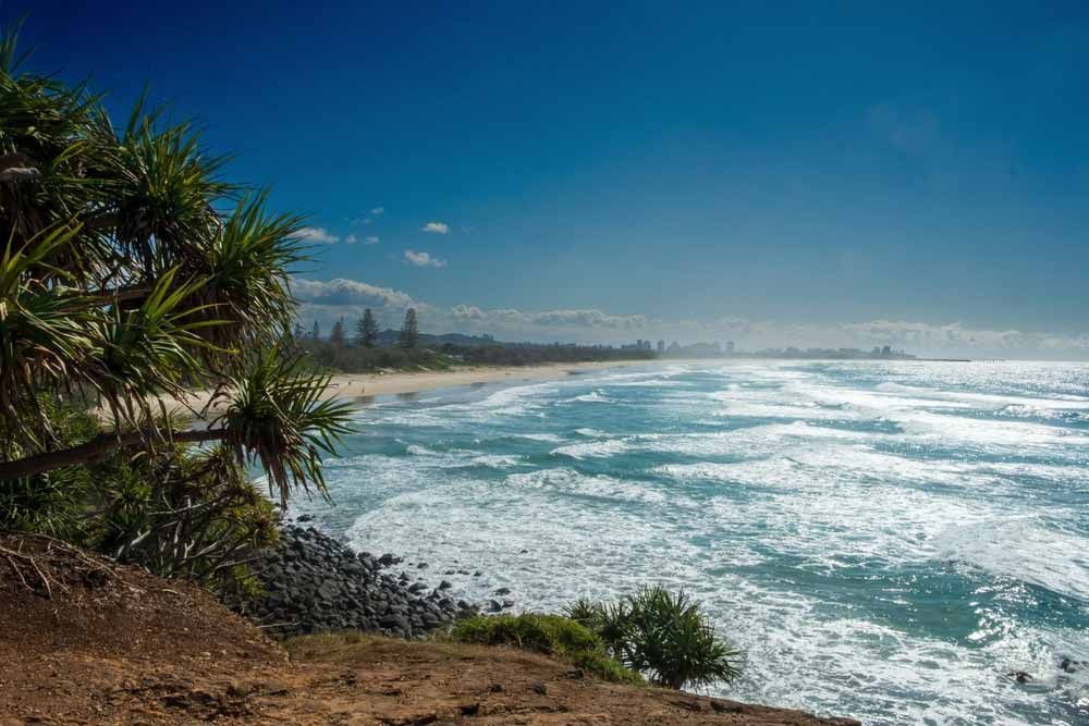 A View Of A Beach From A Cliff Overlooking The Ocean — Shop Fittings Office Furniture Materials Handling In Prestons, NSW