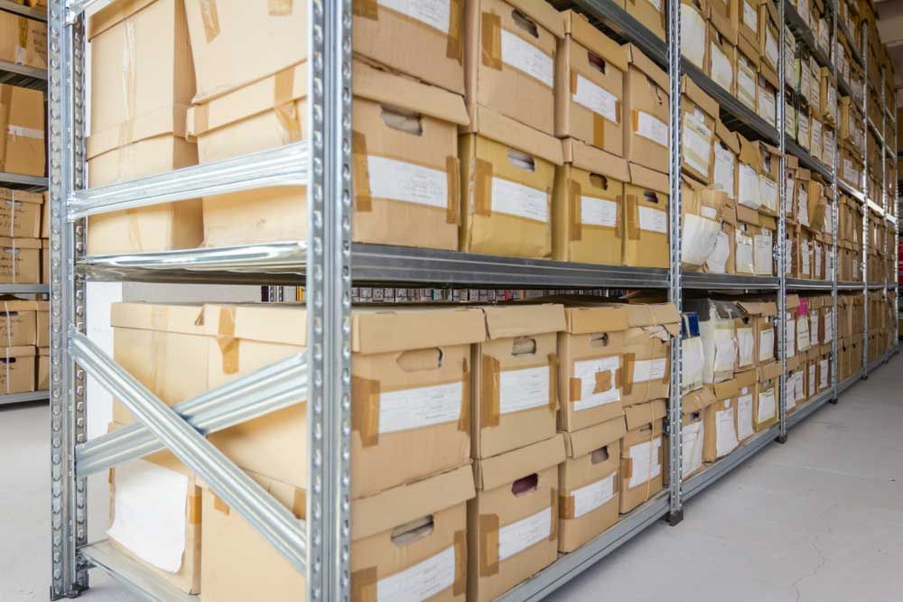 A Warehouse Filled With Lots Of Cardboard Boxes — Shop Fittings Office Furniture Materials Handling In Gosford, NSW