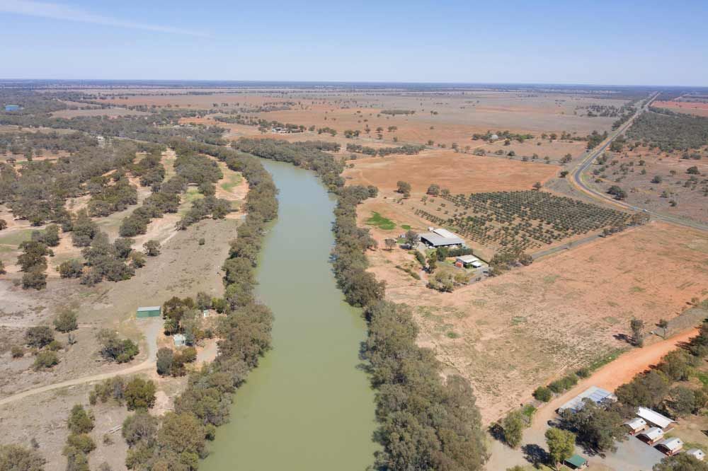 An Aerial View Of A River Surrounded By Trees And A Road — Shop Fittings Office Furniture Materials Handling In Silverwater, NSW