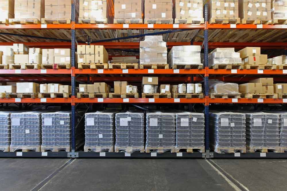 A Warehouse Filled Boxes And Pallets — Shop Fittings Office Furniture Materials Handling In Macquarie Park, NSW