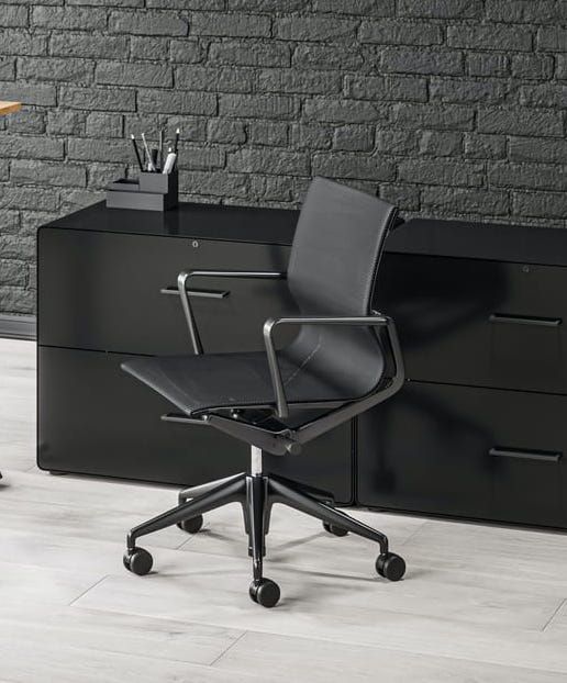 A Black Office Chair Is Sitting In Front — Shop Fittings Office Furniture Materials Handling In Gosford, NSW