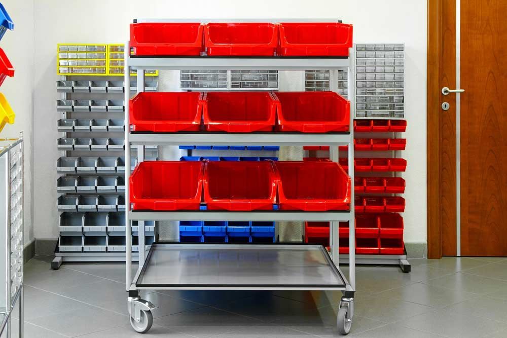 A Shelf With Red Bins On It In A Room — Shop Fittings Office Furniture Materials Handling In Gosford, NSW