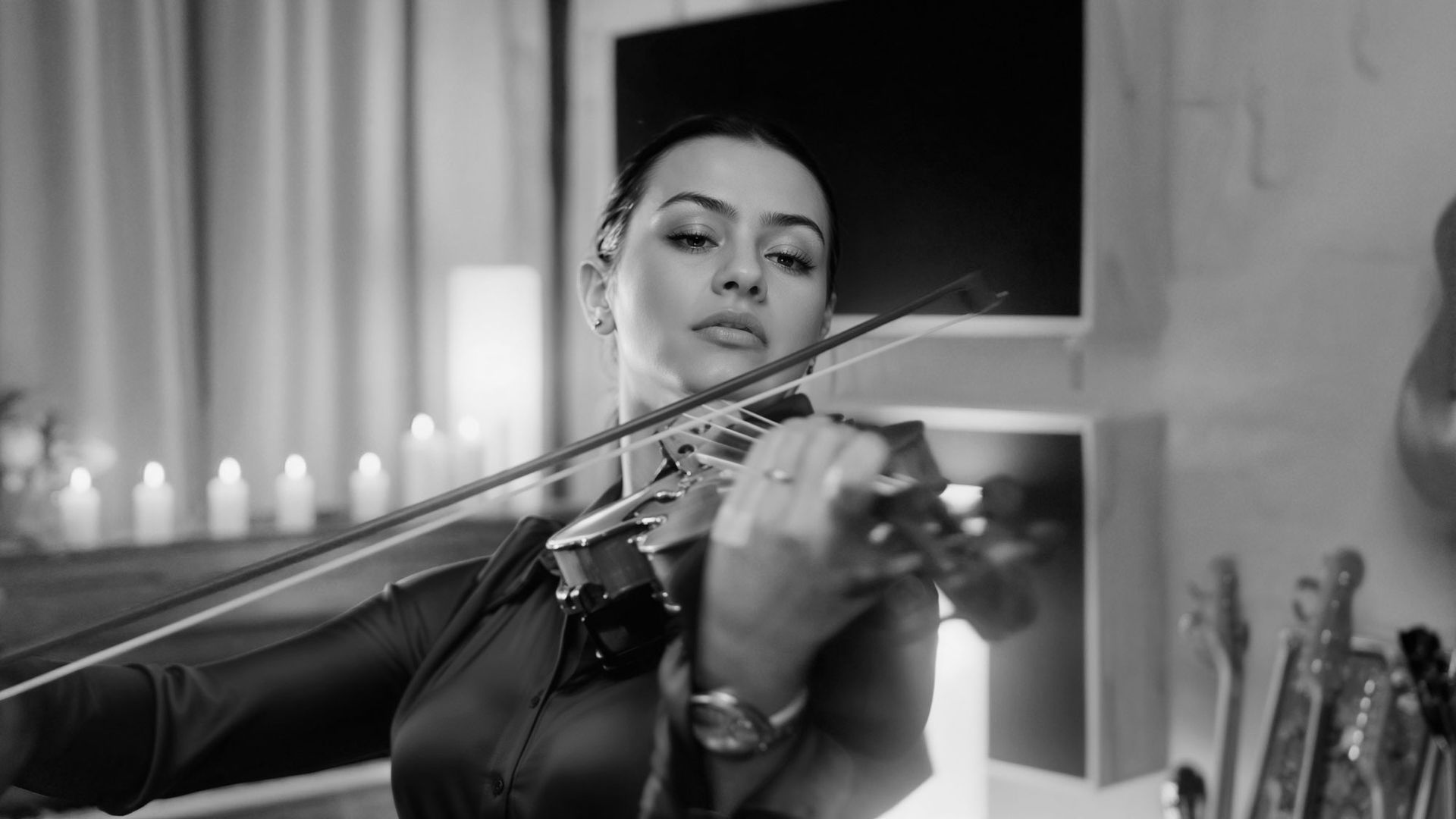 Sofia Luppino playing a violin in a black and white photo.