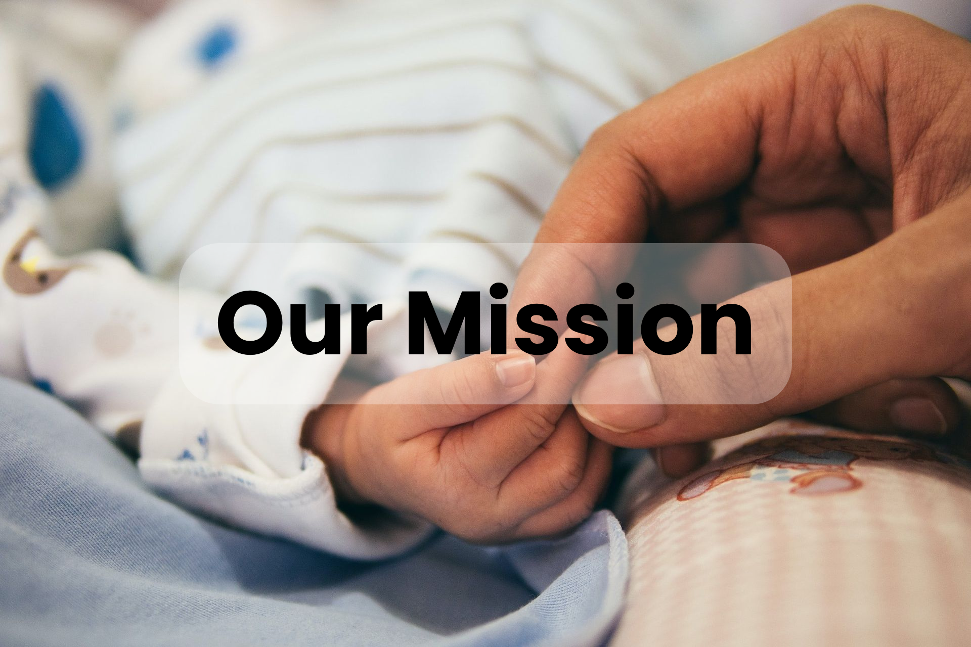 A close up of a person holding a baby 's hand.