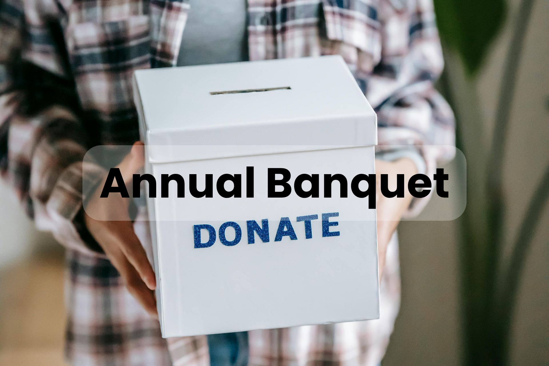 A person is holding a white box that says `` donate ''.