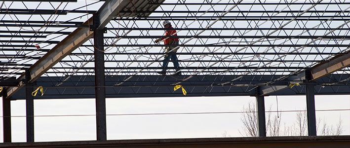 A man is standing on top of a metal structure.
