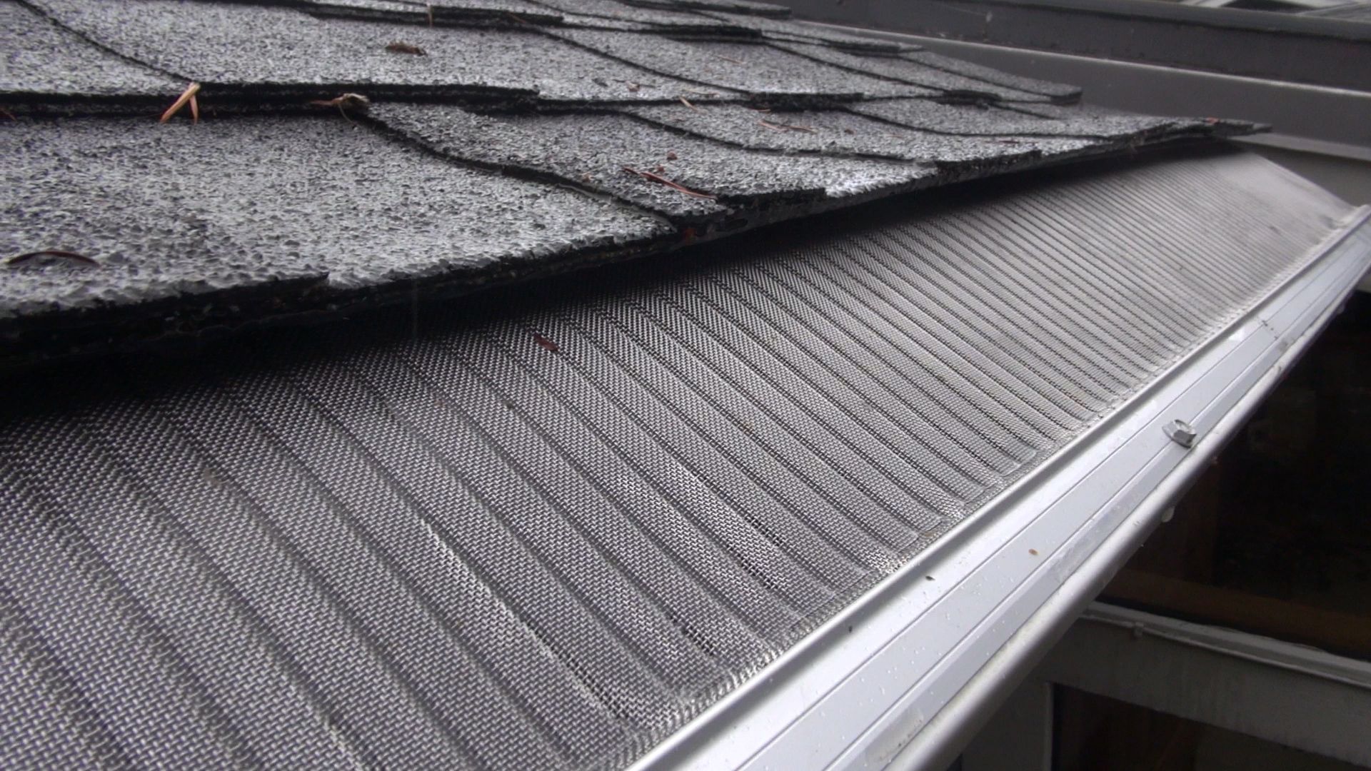A close up of a roof with a gutter on it.