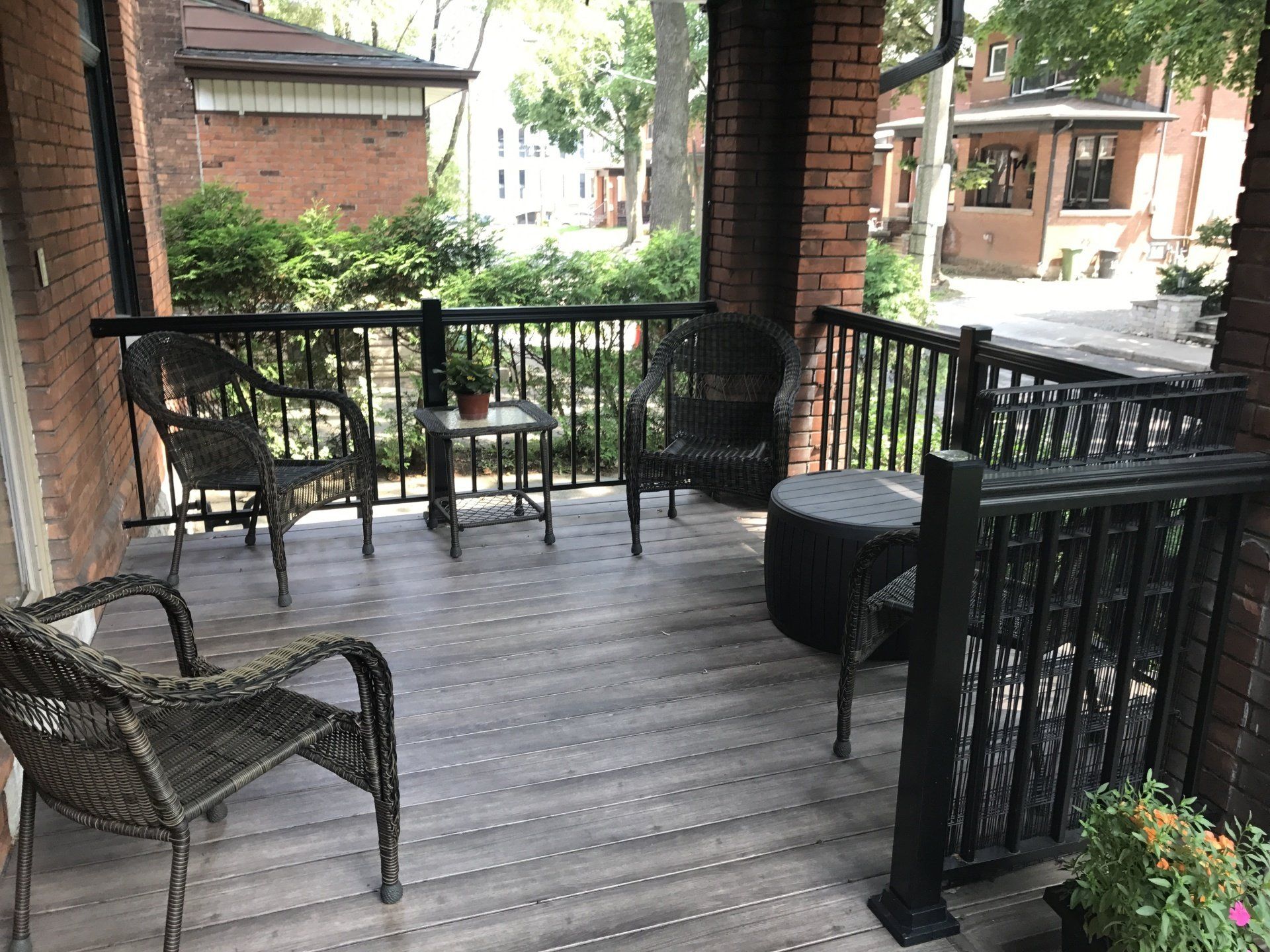 A porch with chairs and a table on it