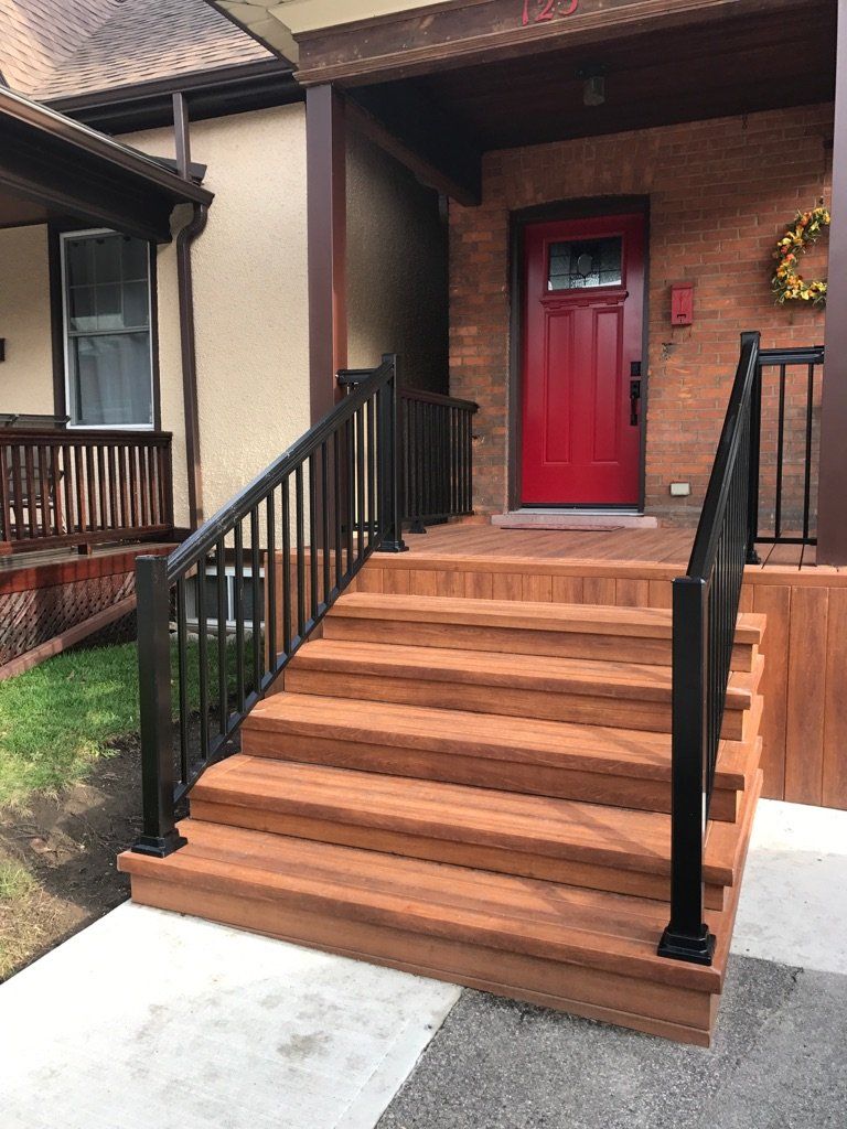 A house with a red door and wooden stairs