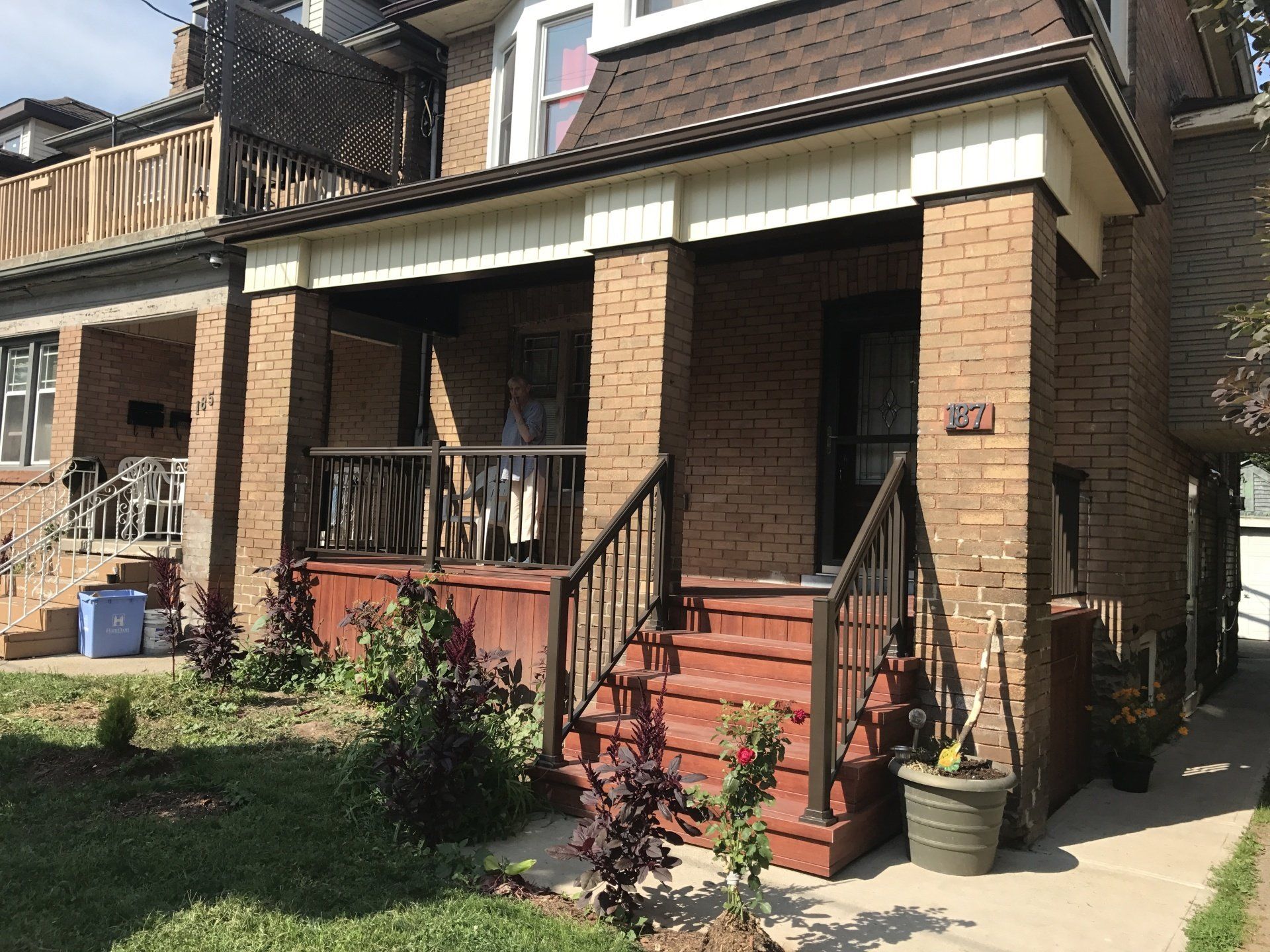 A brick house with a porch and stairs